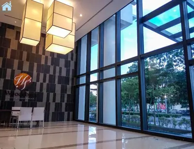 a lobby with large windows and a table and chairs at HomeSweetHome in Perai