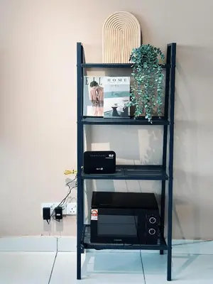 a book shelf with a microwave and a radio at Taiping Centre Point Suite 9 by BWC in Taiping