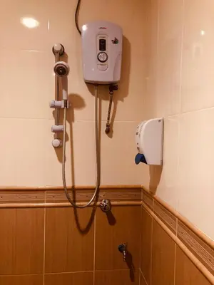 a shower in a bathroom with a camera on the wall at Hotel Chua Gin in Cameron Highlands