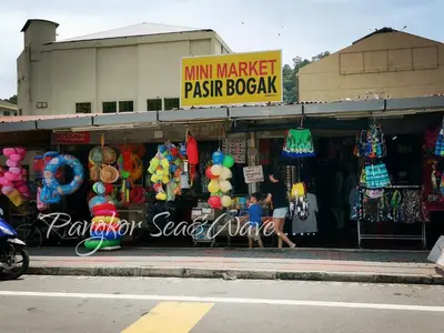 a store on the side of a street with a market at Sea & Wave #1 Coral Bay Apartment in Pangkor