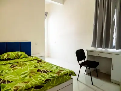 a bedroom with a bed and a chair in it at Kampar Private Roomstay W in Kampar