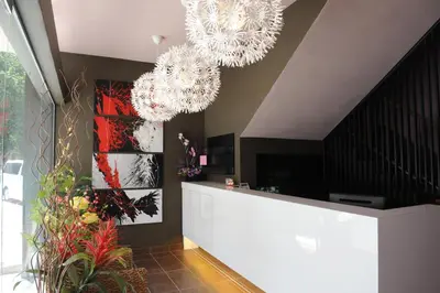 a lobby with two chandeliers hanging from the ceiling at The Osborne Apartments in Ipoh