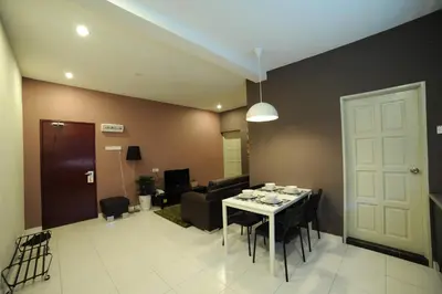 a living room with a table and a couch at The Osborne Apartments in Ipoh