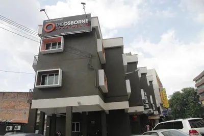 a building with a sign on the side of it at The Osborne Apartments in Ipoh