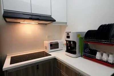 a kitchen with a counter top with a microwave at H2H - Ohayō Ipoh Majestic Ipoh in Ipoh