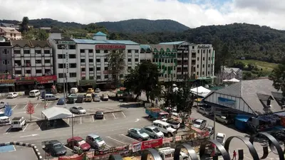 a city with cars parked in a parking lot at Hong Kong Hotel in Brinchang