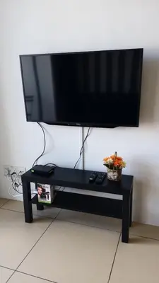 a flat screen tv sitting on top of a black coffee table at Misty Wonderland Cameron Next to Night Market 9 PAX in Cameron Highlands