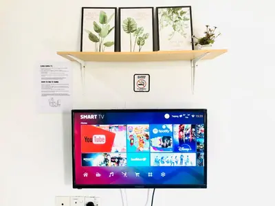 a computer monitor on a wall with a shelf at Homestay Lestary near Taiping Fast WIFI Netflix in Taiping