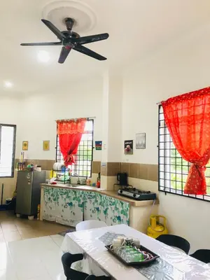 a kitchen with a table and a ceiling fan at Homestay Lestary near Taiping Fast WIFI Netflix in Taiping