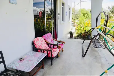 a porch with two chairs and a table at Homestay Lestary near Taiping Fast WIFI Netflix in Taiping