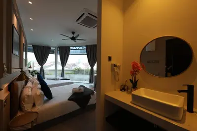 a bedroom with a bed and a sink and a mirror at Manhattan Residence in George Town