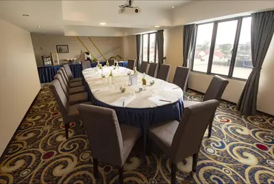 a conference room with a large table and chairs at Kinta Riverfront Hotel & Suites in Ipoh