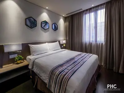 a hotel room with a bed and a window at Ropewalk Piazza Hotel Managed by The Ascott Limited in George Town