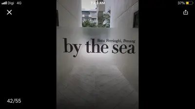 a sign that says by the sea on the side of a building at By the sea Beach BABY in Batu Ferringhi