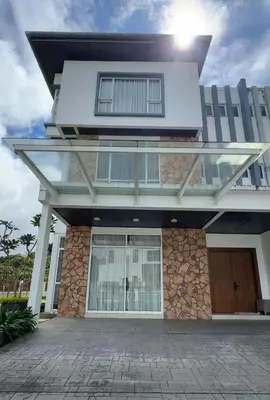 a house with the sun shining on it at Zinnia Residence Tanah Rata in Cameron Highlands