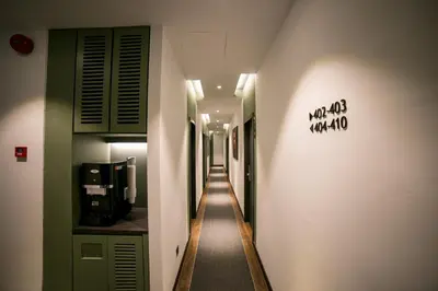 a hallway with a long hallway with a sign on the wall at Eureka Hotel Penang in Bayan Lepas