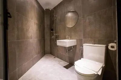 a bathroom with a toilet and a sink at Eureka Hotel Penang in Bayan Lepas