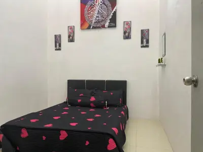 a bedroom with a bed with pink hearts on it at Abg Long Fadhil Homestay in Sungai Petani