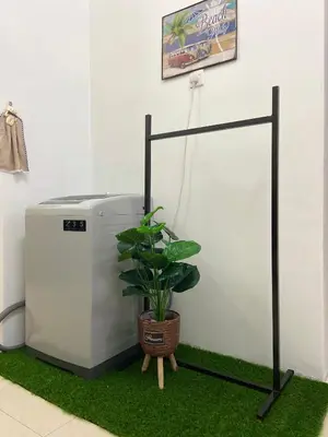a plant sitting next to a white refrigerator at Abg Long Fadhil Homestay in Sungai Petani