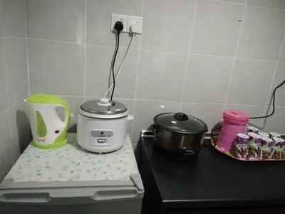 a kitchen counter with a slow cooker and a pot at Casa D'One Homestay D Pasar Malam in Cameron Highlands