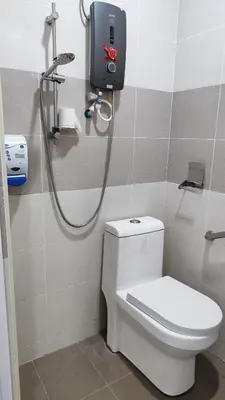 a bathroom with a toilet and a shower at CK Homestay K.Sepetang in Taiping
