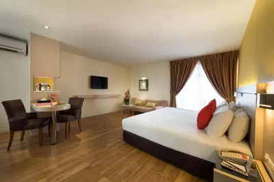a hotel room with a bed and a table and chairs at Hotel Sentral Georgetown @ City Centre in George Town