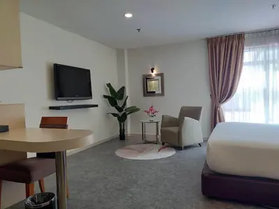 a hotel room with a bed and a desk and a tv at Hotel Sentral Georgetown @ City Centre in George Town