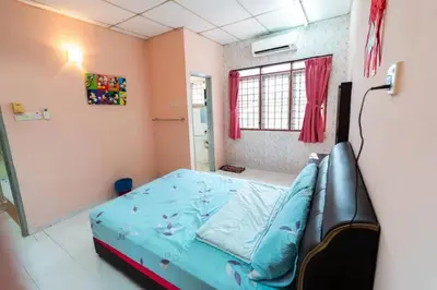 a bedroom with a blue bed in a room with a window at Star Light Homestay in Sitiawan