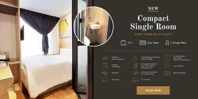 a room with a bedroom with a bed and a mirror at Rivertel in Teluk Intan