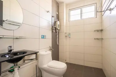 a bathroom with a toilet and a sink and a mirror at COCONUT HOMESTAY Tanjong Karang Sekinchan Kuala Selangor in Kampong Sungai Kajang