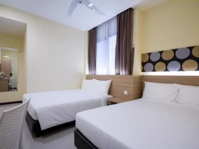 a hotel room with two beds and a window at 118 Hotel Macalister in George Town