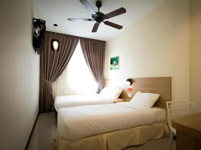 a bedroom with two beds and a ceiling fan at 118 Hotel,Dato Keramat - Self Check In in George Town