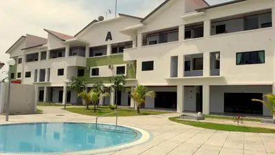 an apartment building with a swimming pool in front of it at Fun Studio Pangkor in Pangkor