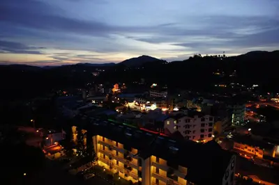 a view of a city at night with a train at Cameron View Apartment @ Crown Imperial Court Brinchang in Cameron Highlands