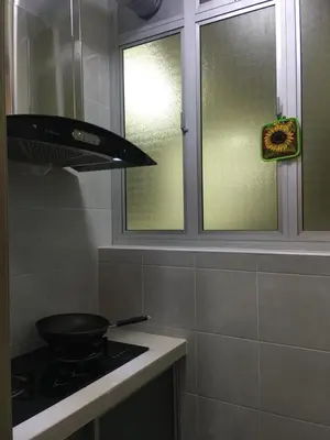 a kitchen with a stove with a pan on the stove at Aalina's Comfort Home - Muslim Homestay in Cameron Highlands