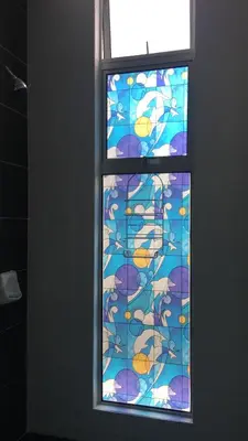 a window in a bathroom with a colorful glass at Aalina's Comfort Home - Muslim Homestay in Cameron Highlands