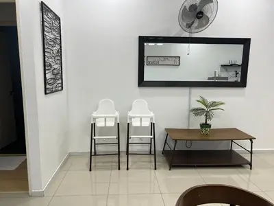 a dining room with a table and two chairs and a mirror at Home Away from Home in Taiping - 3R4B Family & Group Friendly! in Taiping