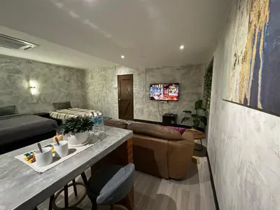 a living room with a bed and a couch at Ipoh Zing Vale - Family & Couple Suite in Ipoh