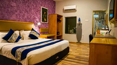 a bedroom with a large bed with a purple wall at K GARDEN HOTEL (IPOH) SDN BHD in Ipoh