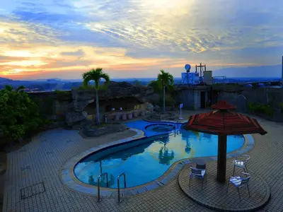 a view of a swimming pool with an umbrella at Emerald Puteri Hotel in Sungai Petani