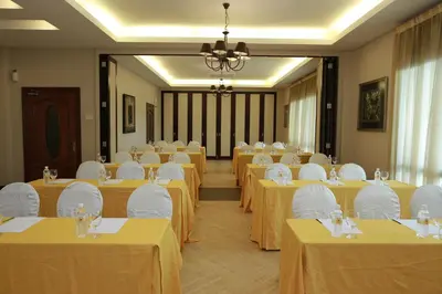 a room full of tables with yellow table cloth at RPGC Garden Hotel in Ipoh