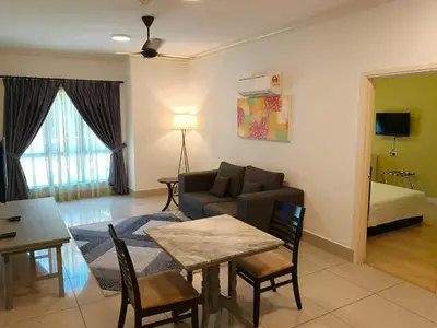a living room with a couch and a table at RPGC Garden Hotel in Ipoh
