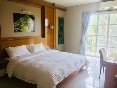a bedroom with a large bed and a window at Guesthouse Dragon Place in Taiping