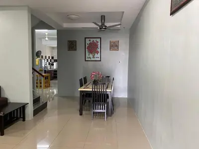 a dining room with a table and a ceiling fan at Makmur homestay in Taiping