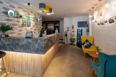 a restaurant with a counter and chairs in a room at Apple Hotel Times Square in George Town