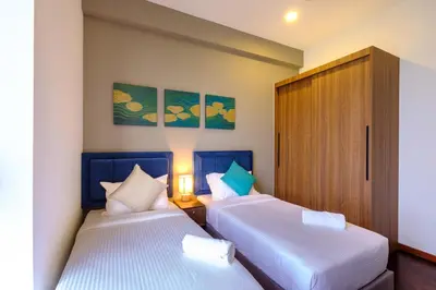 two beds in a hotel room with two beds sidx sidx sidx at Tanjung Point Residences in George Town
