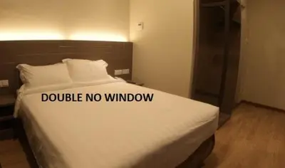 a bed with a sign that says double no window at U Design Hotel Kuala Lipis in Kuala Lipis