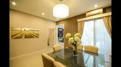 a dining room with a table with chairs and a vase of flowers at The heaven in sunway ipoh in Ipoh