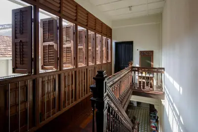 a hallway with a staircase in a building with wood paneling at Noordin Mews in George Town
