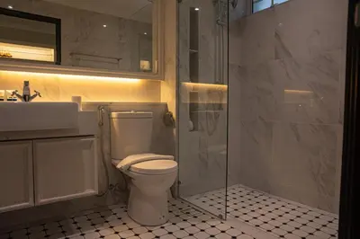 a bathroom with a toilet and a shower and a sink at White Mansion Penang in George Town
